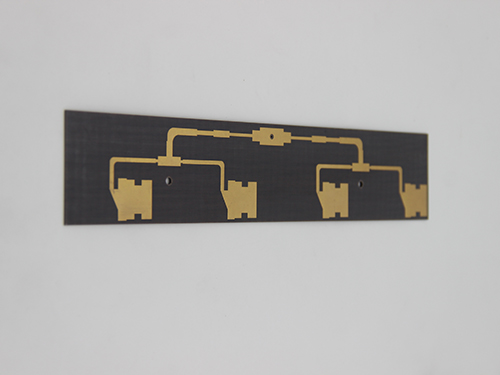 Symmetrical branching gold circuit on dark substrate: Four vertical paths leading to notched metal contact pads, showcasing aesthetic precision for high-reliability signal transmission or precision sensor interfacing