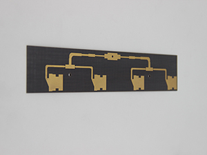 Symmetrical branching gold circuit on dark substrate: Four vertical paths leading to notched metal contact pads, showcasing aesthetic precision for high-reliability signal transmission or precision sensor interfacing